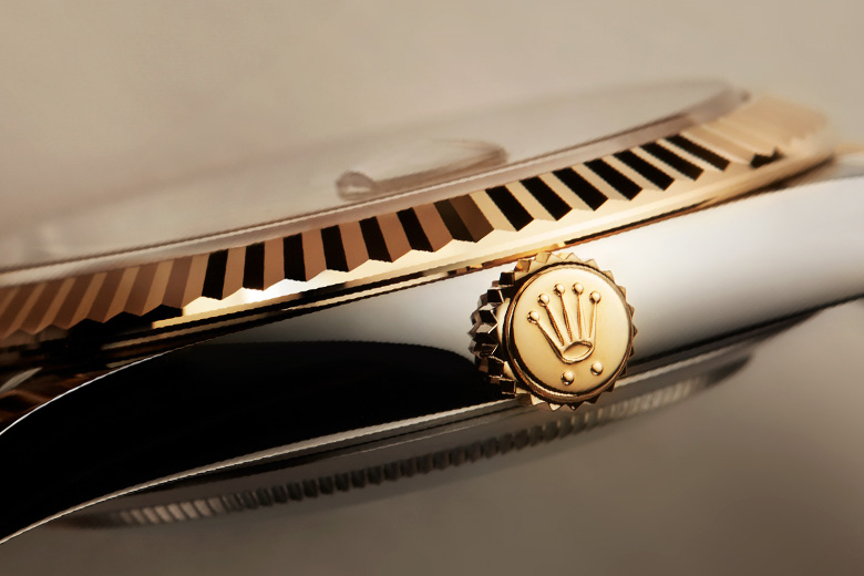 Rolex Datejust, highlighting fluted bezel and the crown. 